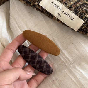 Brown plaid and solid caramel fabric BB hair clips for girls in a hand-held display