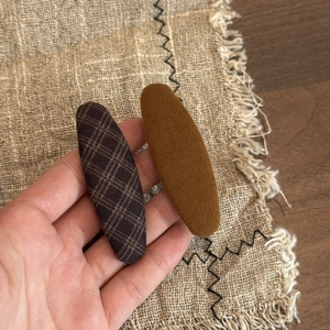 Brown plaid hair clips set in warm caramel tones with textured fabric finish
