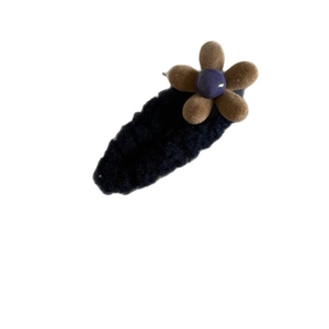 Winter plush flower hair clip with brown petals and purple bead on black base