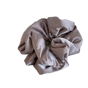 Elegant mauve satin padded scrunchie with a soft silk texture for bun hairstyles