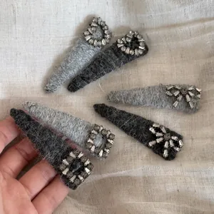 Detail view of plush fabric hair clips with sparkling rhinestone butterfly patterns