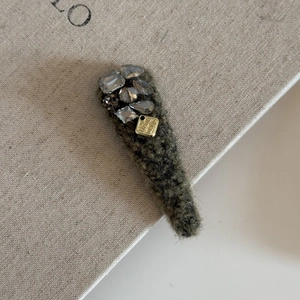 Elegant olive green wool hair clip with sparkling rhinestones and handmade metal tag