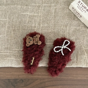 Pair of plush burgundy hair clips with rhinestone bow and cute bear charms for women
