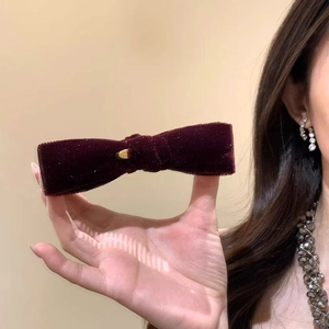 Elegant burgundy velvet bow hair clip with gold metal accent for high ponytail styles