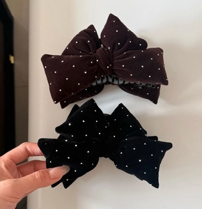 Detail view of large velvet bow hair claws with sparkling rhinestones in black and brown
