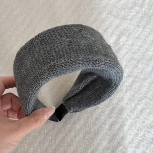 Close-up of wide mustard green knitted velvet headband showing soft warm fabric texture