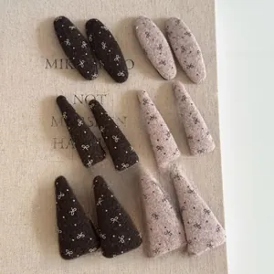 Close-up of pink and brown felt bow hair clips set with polka dot patterns