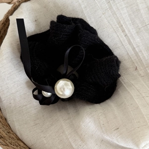 Elegant black knitted scrunchie with satin bow and faux pearl detail for women