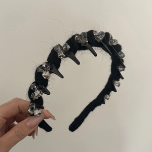 Detail of vintage wool headband with grey crystal beads and black spiked studs