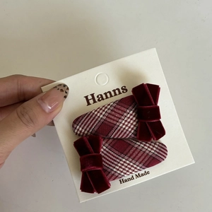 Handmade Christmas hair clip set with red plaid fabric and velvet bow design