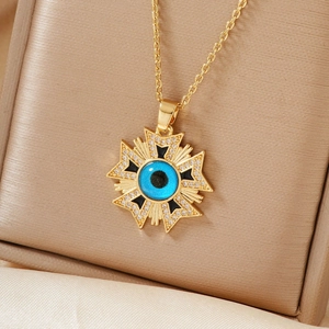 Macro detail of star medal necklace with blue evil eye pendant and sparkling crystals