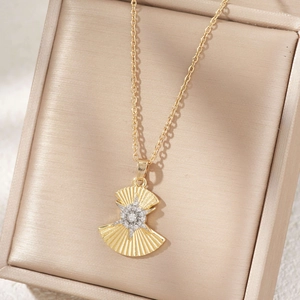 Golden fan-shaped necklace with central star-shaped zircon pendant on beige silk