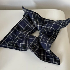British style navy blue plaid scrunchie with classic grid pattern on white background