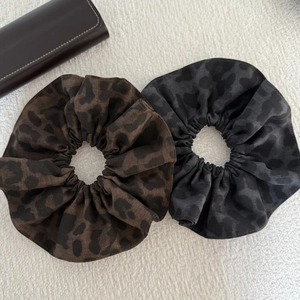 Set of vintage leopard print scrunchies in brown and grey fabric for stylish hair styling