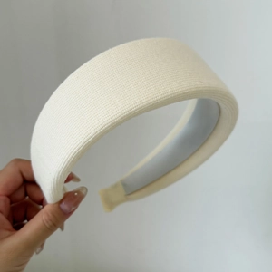 Creamy thick knitted headband for women featuring high top volume and woven texture