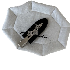 Black acetic acid star hair clip with three silver rhinestone stars and metal alligator grip