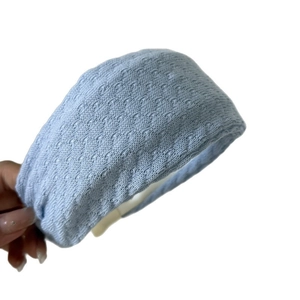 Light blue knitted headband with textured floral hollow pattern for women
