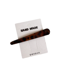 Classic leopard print acetate duckbill hair clip on a white handmade display card