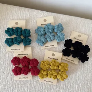 Handmade crochet flower hair clips in five gradient colors on display cards