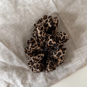 Close-up of leopard print bubble pleated hair claw clip with textured fabric details