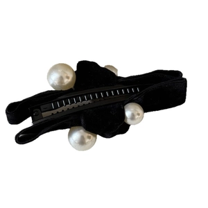 Elegant black velvet banana hair clip with four large white artificial pearls on white background
