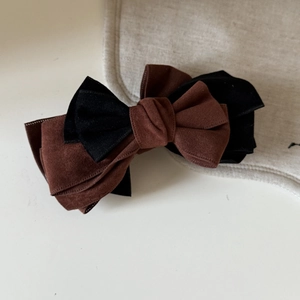 Elegant dual-tone bow banana clip in coffee and black suede for stylish ponytails