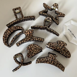 Retro leopard print hair claw clip set with various geometric shapes on white background