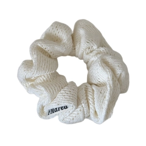 Chic cream knit scrunchie with FMarea label for elegant ponytail styling
