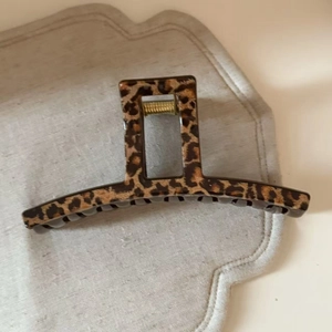 Macro detail of high-quality leopard print hair claw clip with sturdy metal spring