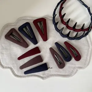 Detailed knit texture of vintage fabric hair clips and non-slip tooth headbands in deep colors