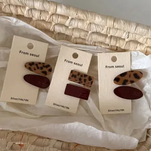 Acetate leopard print and burgundy hair clip sets displayed on minimalist cards