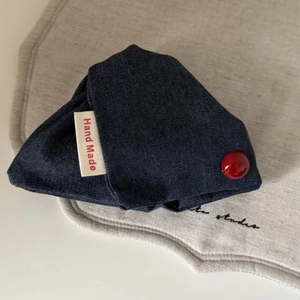 Handmade navy blue denim triangle pouch with red bead detail and artisan woven label