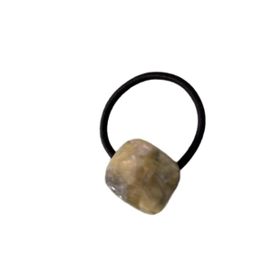 Retro geometric acetate hair tie with a square amber marble pattern bead on black elastic