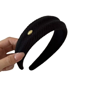 Black knit velvet headband with gold love emblem, stylish hair accessory for women