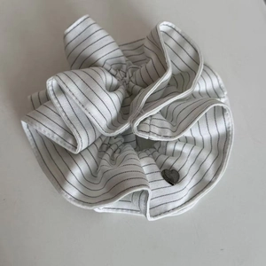 Classic navy blue striped scrunchie with a small heart charm on white background