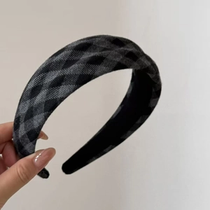 Detail of grey plaid woolen padded headband showing thick fabric texture and nonslip lining