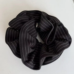 Detail of navy blue heart stripe scrunchie with high elasticity and cotton blend texture