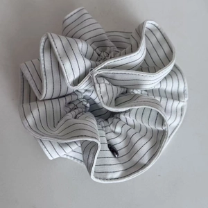 Detail of navy stripe scrunchie showing fabric texture and high-elastic pleated design