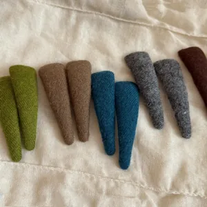 Detail of fabric-wrapped teardrop hair clips in various warm autumn colors