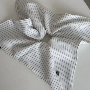 Detail of navy blue heart striped scrunchie with French style fabric and elegant folds
