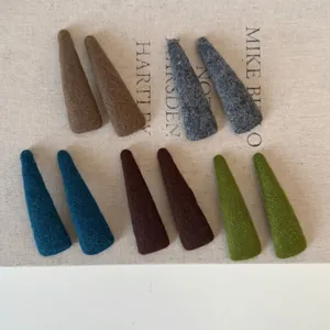 Set of 10 mori style knit fabric hair clips in five earthy colors on a vintage background