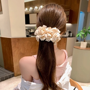 Elegant beige polka dot rose fabric banana hair clip styled on a low ponytail hair