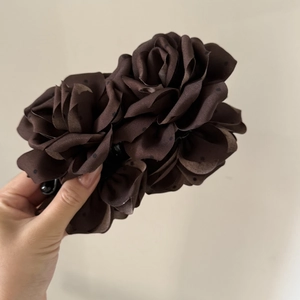 Detail of coffee brown polka dot rose hair clip with satin fabric flower petals