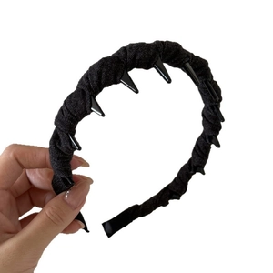 Punk style black fabric headband with decorative plastic spikes for gothic fashion look