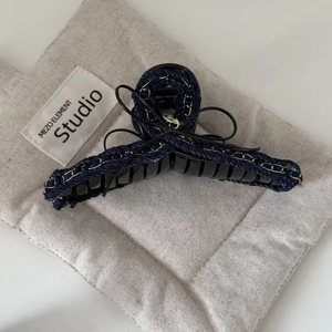 Denim fabric shark hair claw with silver metal chain stitching and black ribbon bow