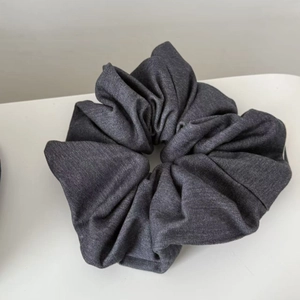 Deep grey oversized scrunchie in high-quality suit fabric with textured folds for women