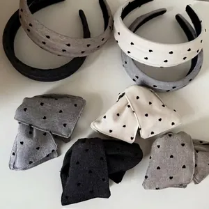 Grey and white fabric headband and bow hair clip set with black heart patterns