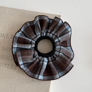 Plaid checkered scrunchie in brown and light blue colors for elegant hair styling