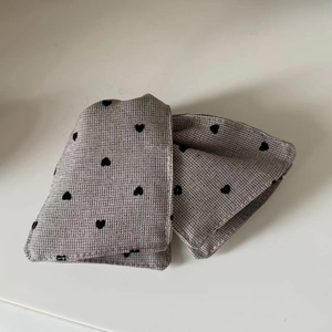 Detail shot of grey heart pattern fabric texture on the elegant hair accessory