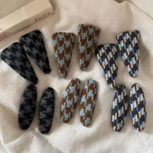 Detail view of woven houndstooth BB hair clips in vintage plaid wool fabric styles
